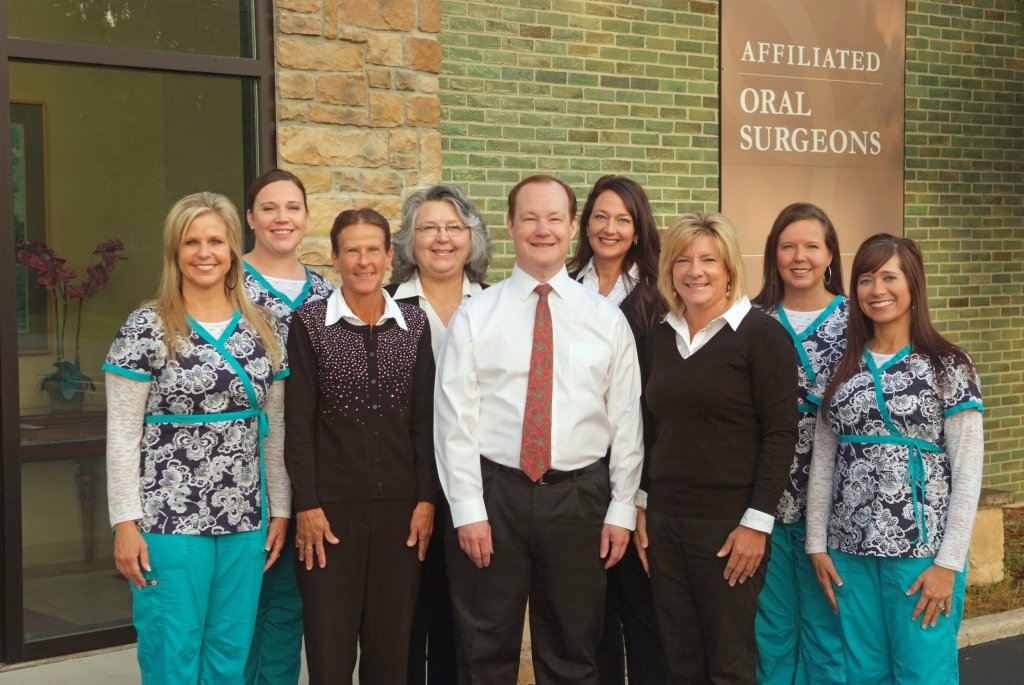 Dr. Luna and the full staff in front of the office building