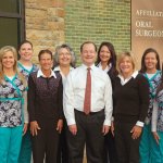 Dr. Luna and the full staff in front of the office building